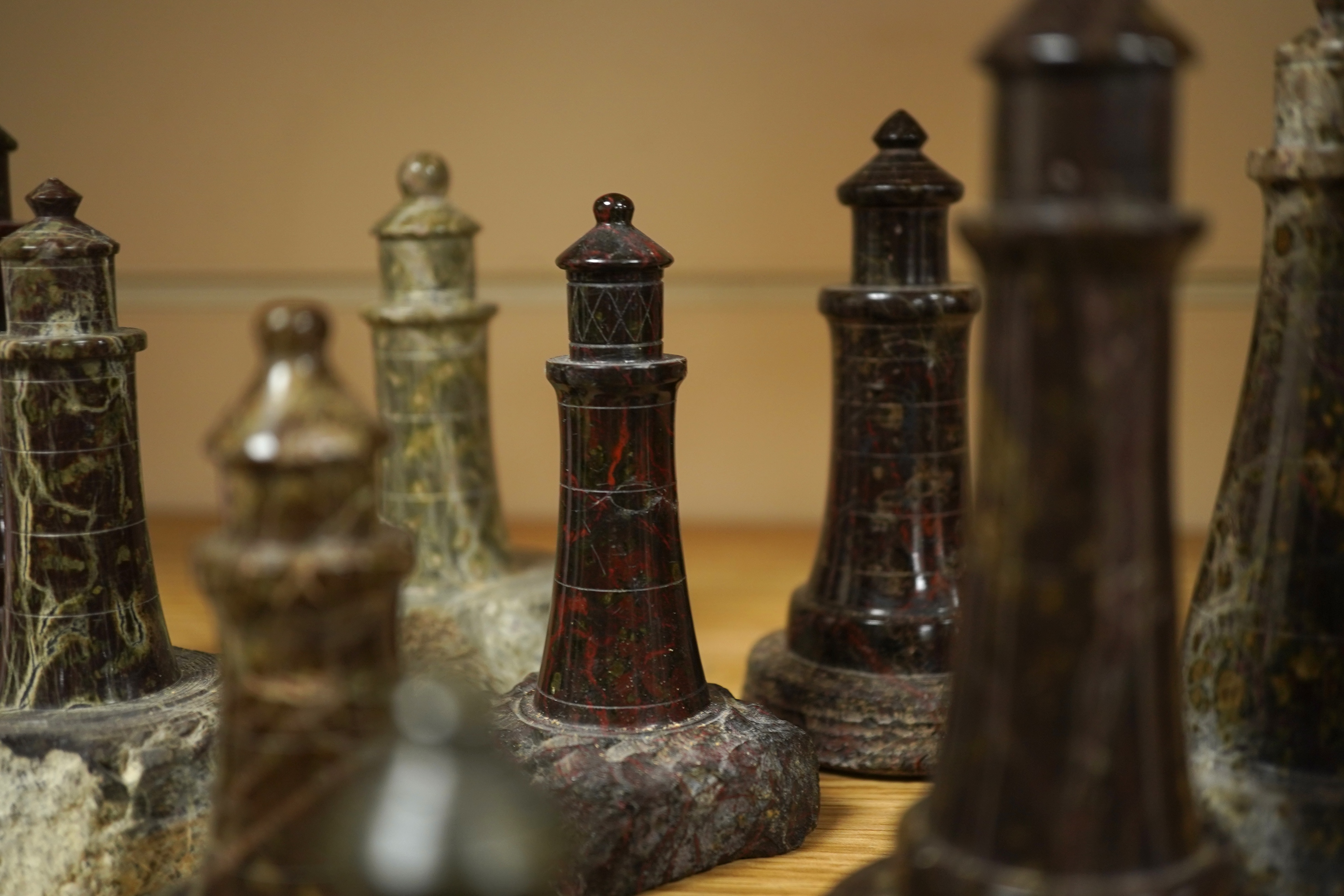 A collection of Cornish serpentine stone carved lighthouses, tallest 13cm high